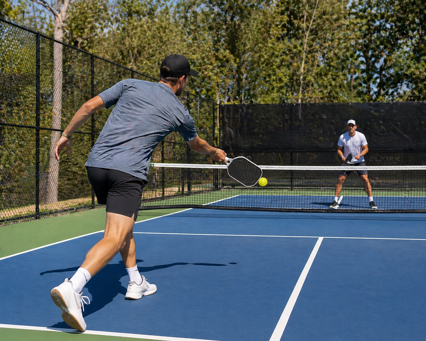 A pickleball player preparing to strike a ball near the kitchen